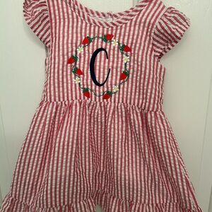 Classic monogrammed C seersucker girl’s red and white dress with strawberries